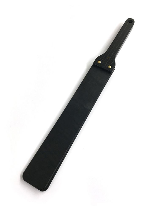 A thick black leather strap with a split end guaranteed to burn bottoms